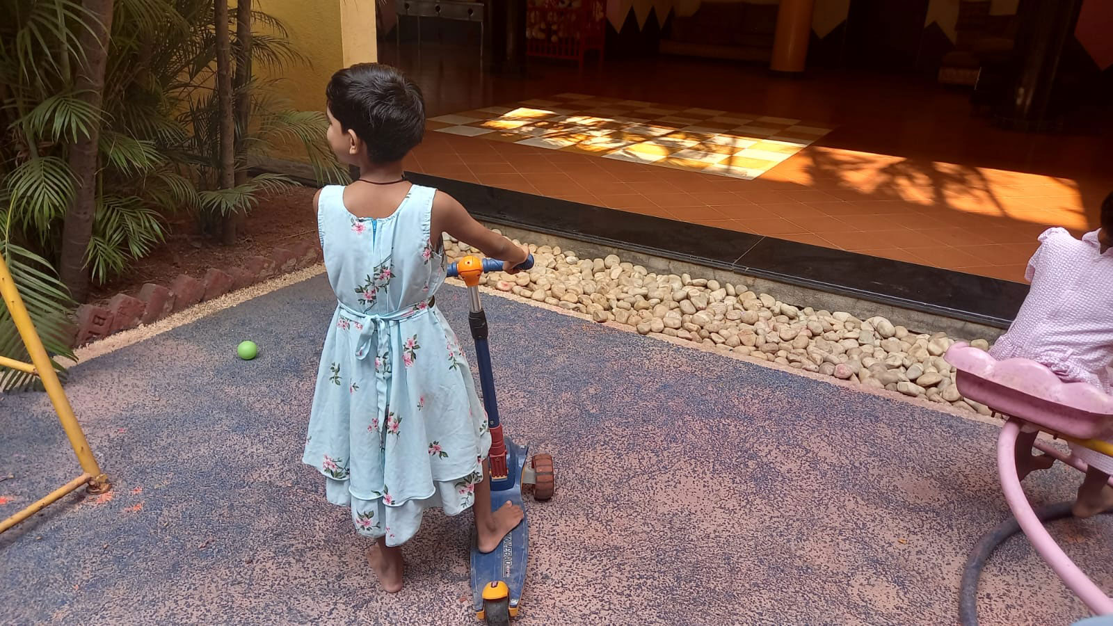 ADOPTION: Child on tri-cycle in the ground floor play area of our child care centre